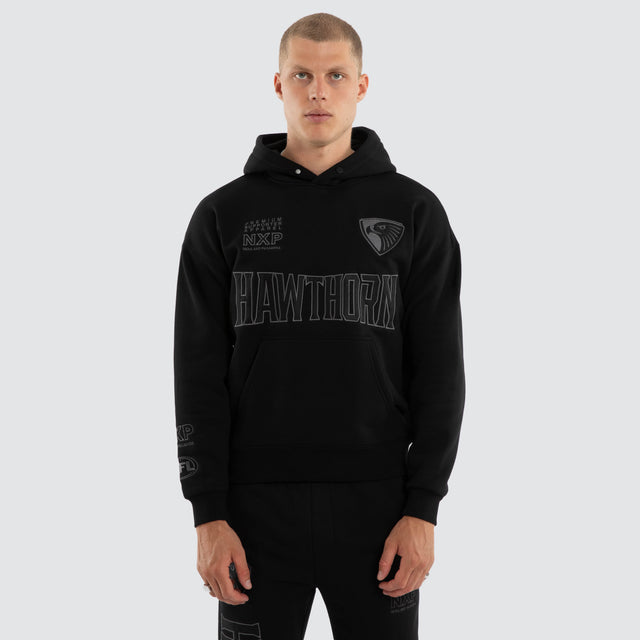 Model wears Hawthorn Hawks AFL Persistent Hoodie Jet Black Hoodies in Black - Image 4