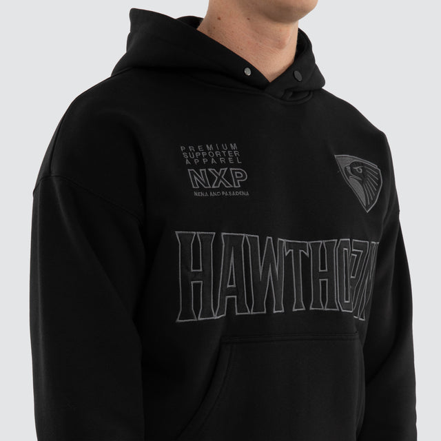 Model wears Hawthorn Hawks AFL Persistent Hoodie Jet Black Hoodies in Black - Image 2