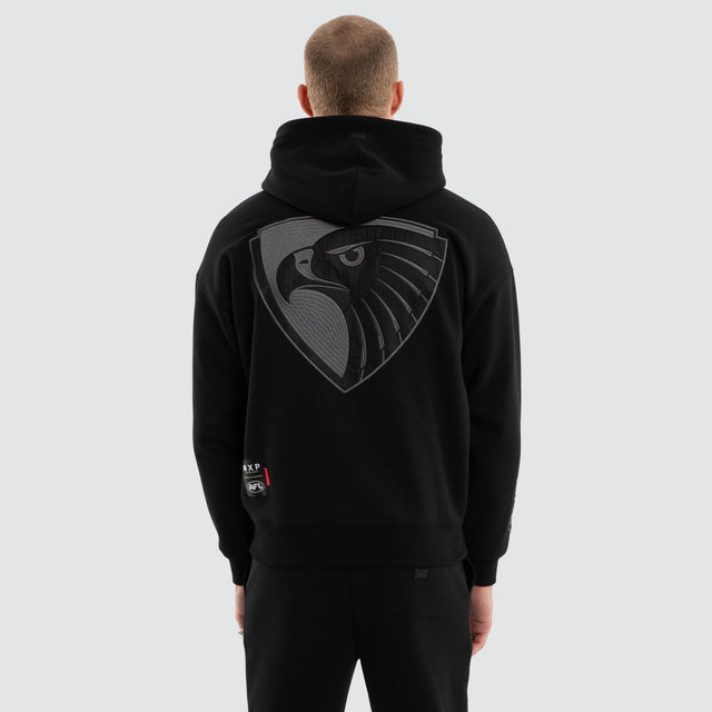 Model wears Hawthorn Hawks AFL Persistent Hoodie Jet Black Hoodies in Black - Image 3
