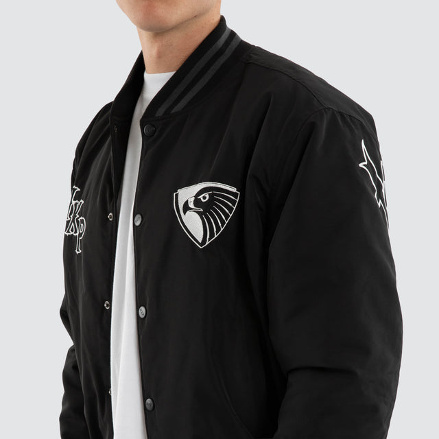 Model wears Hawthorn Hawks AFL Retro Bomber Jet Black Jackets in Black - Image 4