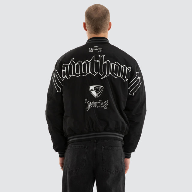 Model wears Hawthorn Hawks AFL Retro Bomber Jet Black Jackets in Black - Image 2