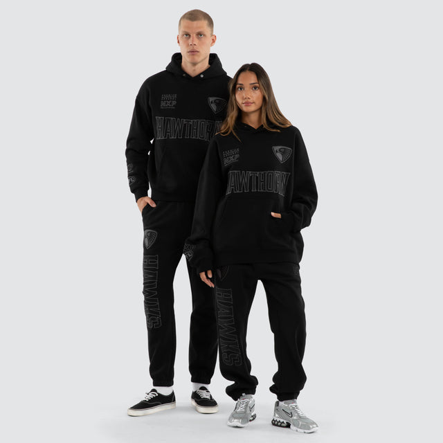 Model wears Hawthorn Hawks AFL Perform Trackpant Jet Black Trackpants in Black - Image 5