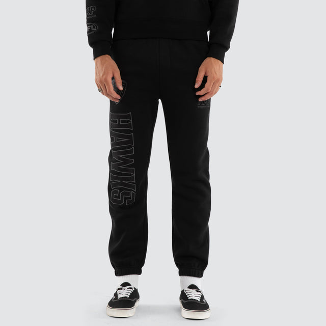 Model wears Hawthorn Hawks AFL Perform Trackpant Jet Black Trackpants in Black - Image 7