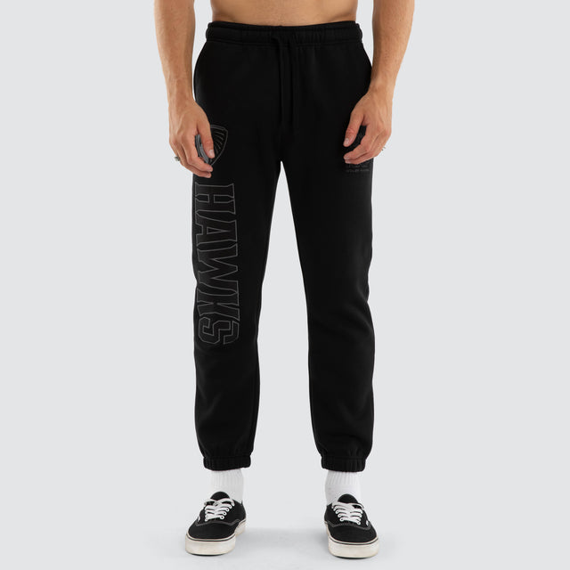Model wears Hawthorn Hawks AFL Perform Trackpant Jet Black Trackpants in Black - Image 3