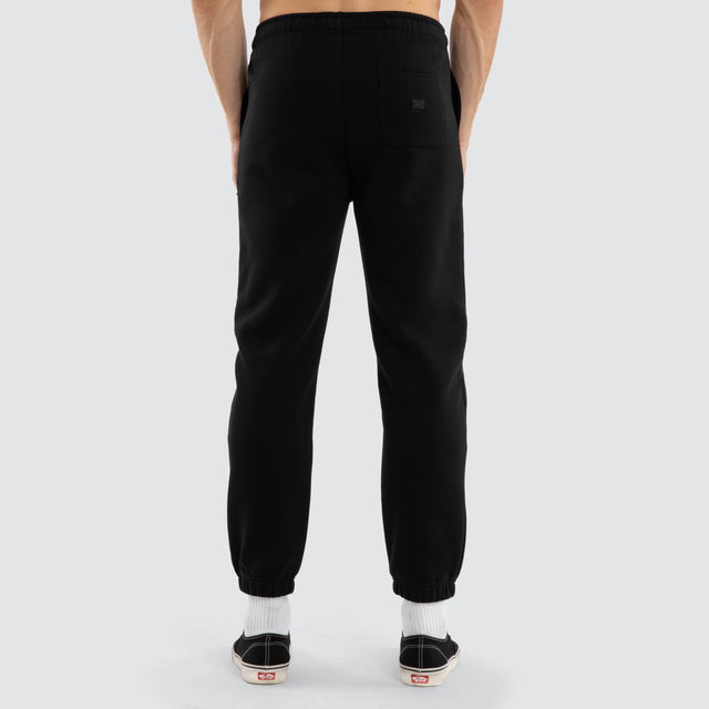 Model wears Hawthorn Hawks AFL Perform Trackpant Jet Black Trackpants in Black - Image 4