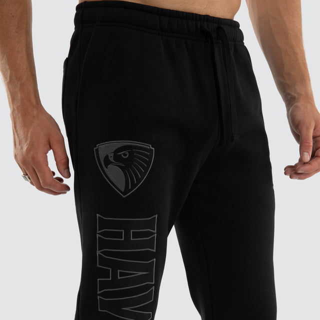 Model wears Hawthorn Hawks AFL Perform Trackpant Jet Black Trackpants in Black - Image 6