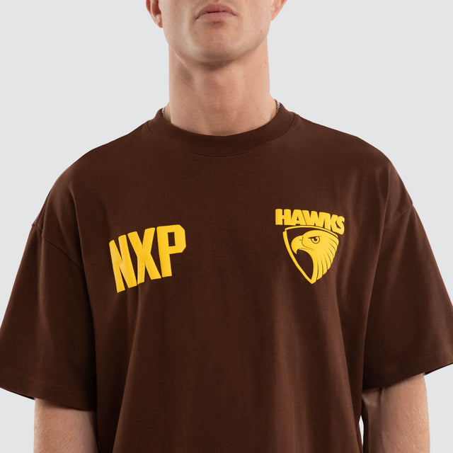 Model wears Hawthorn Hawks AFL Archive Raptor Tee Brown T-Shirts in Brown - Image 5
