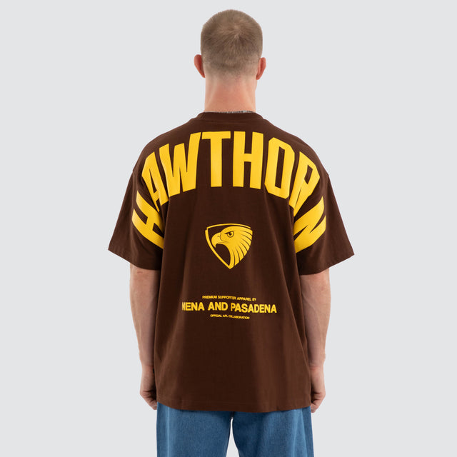 Model wears Hawthorn Hawks AFL Archive Raptor Tee Brown T-Shirts in Brown - Image 4