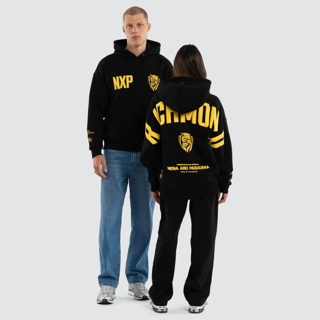 Model wears Richmond Tigers AFL Top Tier Hoodie Jet Black Hoodies in Black - Image 5