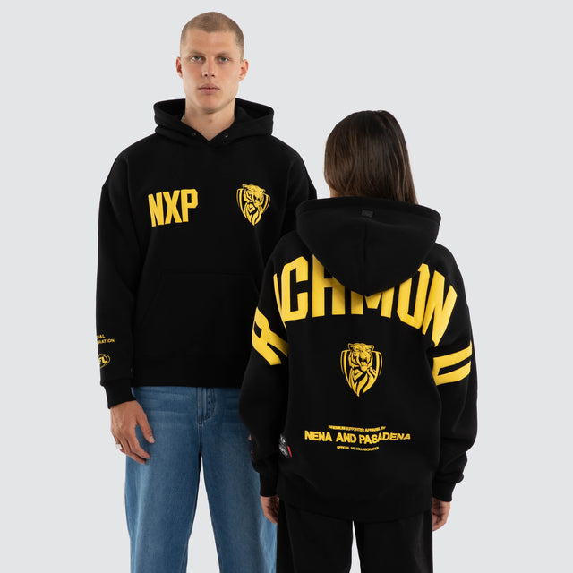 Model wears Richmond Tigers AFL Top Tier Hoodie Jet Black Hoodies in Black - Image 1