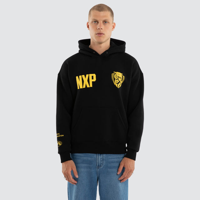 Model wears Richmond Tigers AFL Top Tier Hoodie Jet Black Hoodies in Black - Image 4