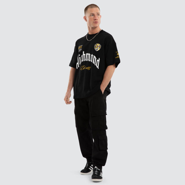 Model wears Richmond Tigers AFL Gold Raptor Tee Jet Black T-Shirts in Black - Image 7