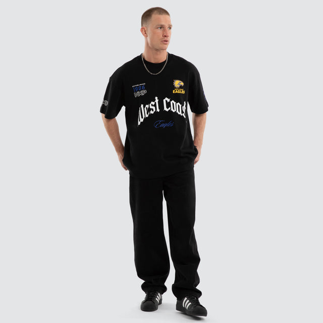 Model wears West Coast Eagles AFL Gold Raptor Tee Jet Black T-Shirts in Black - Image 7