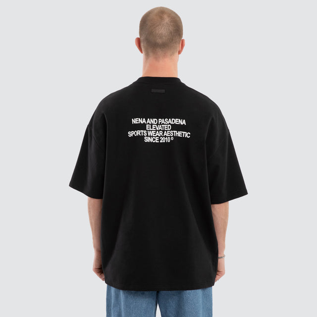 Model wears Outlap Gallery Tee Black  T-Shirts in Black - Image 2