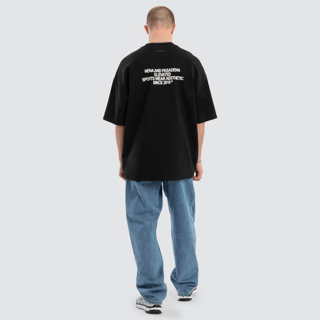 Model wears Outlap Gallery Tee Black  T-Shirts in Black - Image 4