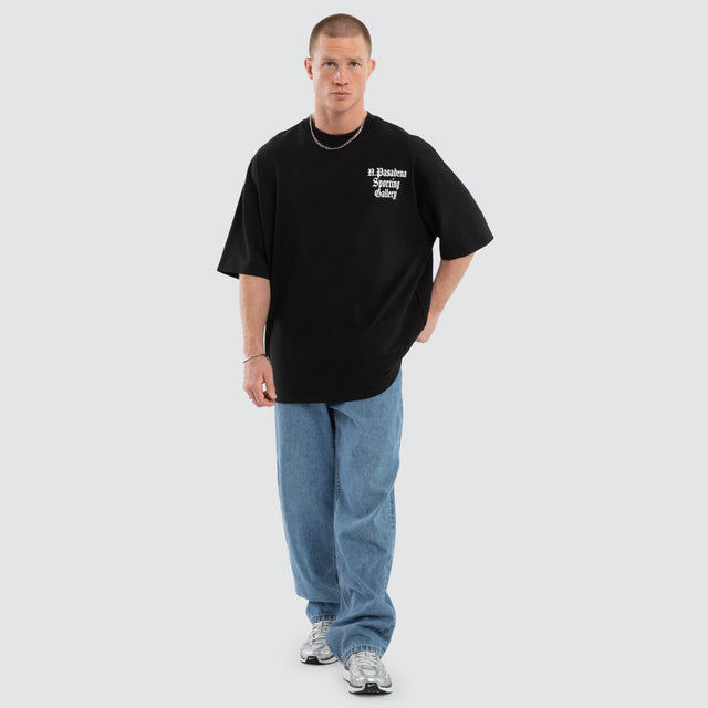 Model wears Outlap Gallery Tee Black  T-Shirts in Black - Image 5