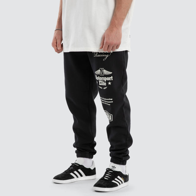 Model wears Parade Trackpant Pigment Black  Trackpants in Black - Image 1