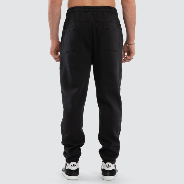 Model wears Parade Trackpant Pigment Black  Trackpants in Black - Image 5