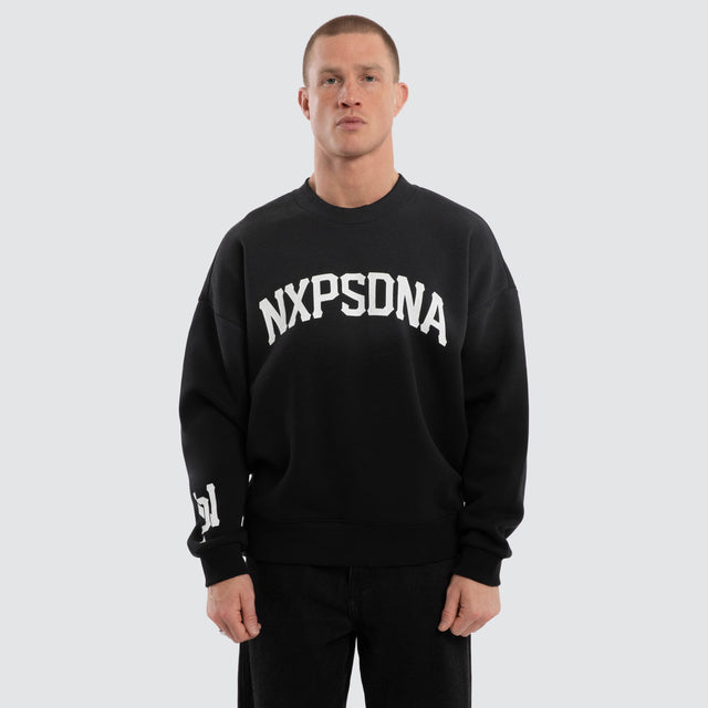 Model wears Halo Box Fit Hoodie Sunbleached Black  Jumpers in Black - Image 1