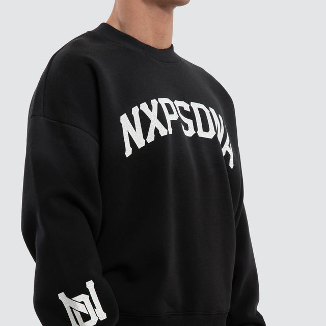 Model wears Halo Box Fit Hoodie Sunbleached Black  Jumpers in Black - Image 3