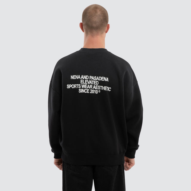 Model wears Halo Box Fit Hoodie Sunbleached Black  Jumpers in Black - Image 2