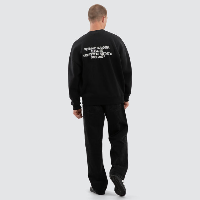 Model wears Halo Box Fit Hoodie Sunbleached Black  Jumpers in Black - Image 4