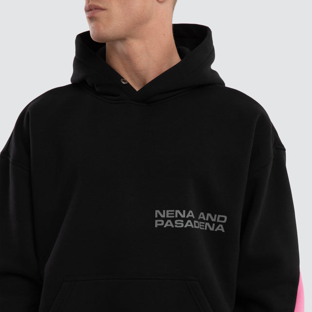 Model wears Zone Box Fit Hoodie Black and Pink  Hoodies in Black - Image 3