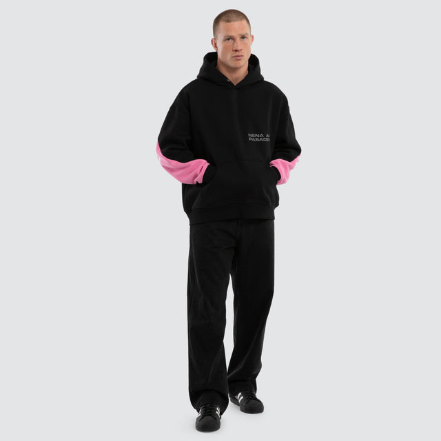 Model wears Zone Box Fit Hoodie Black and Pink  Hoodies in Black - Image 4