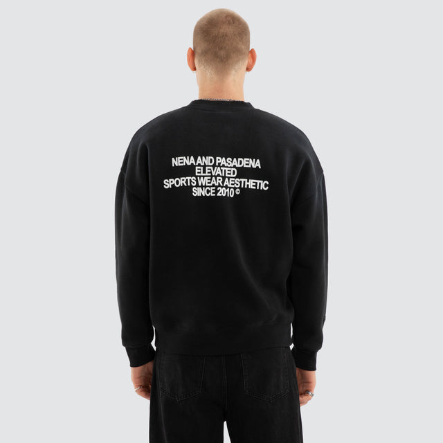 Model wears Halo Box Fit Sweater Sunbleached Black Jumpers in Black - Image 4