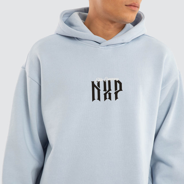 Model wears Dominate Relaxed Curved Hoodie Skyway Hoodies in Blue - Image 3