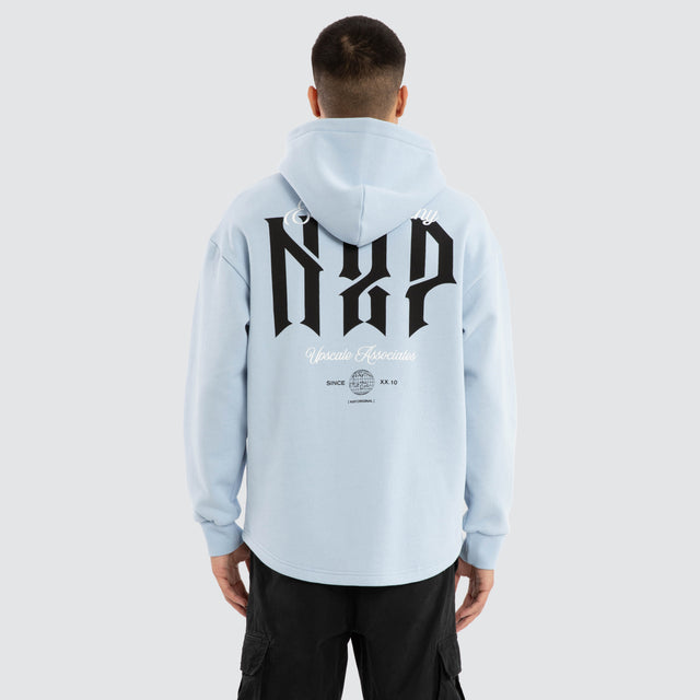 Model wears Dominate Relaxed Curved Hoodie Skyway Hoodies in Blue - Image 2