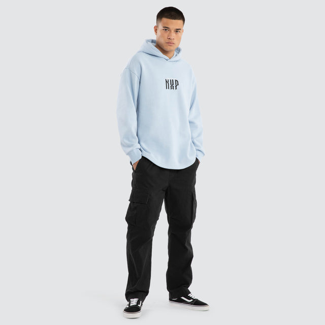 Model wears Dominate Relaxed Curved Hoodie Skyway Hoodies in Blue - Image 5