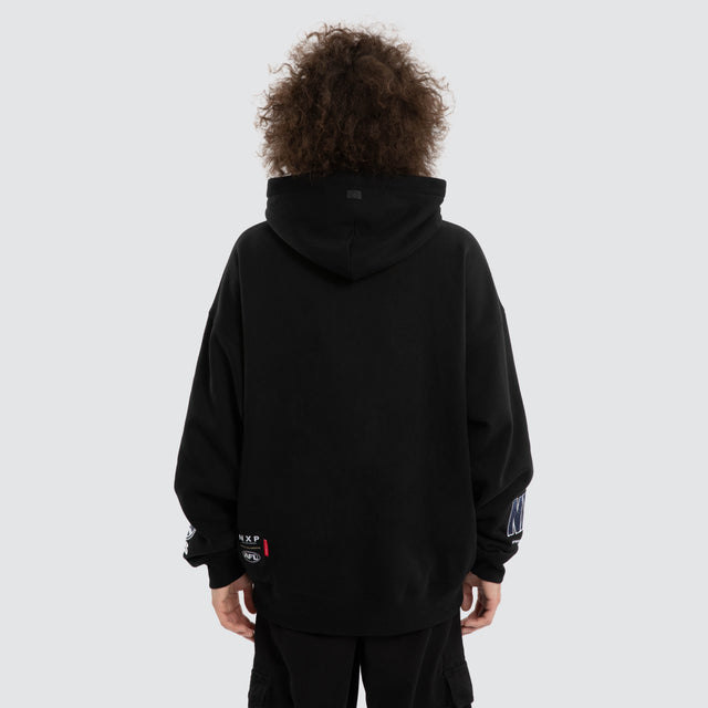 Model wears Ben Davis Geelong Cats AFL Box Fit Hoodie Jet Black Hoodies in Black - Image 5