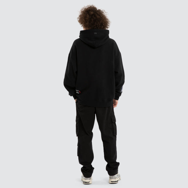 Model wears Ben Davis Geelong Cats AFL Box Fit Hoodie Jet Black Hoodies in Black - Image 7