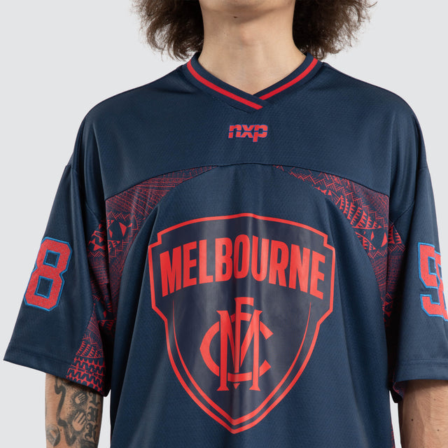Model wears Ben Davis Melbourne Demons AFL Mesh Jersey Dees Navy Jerseys in Blue - Image 2