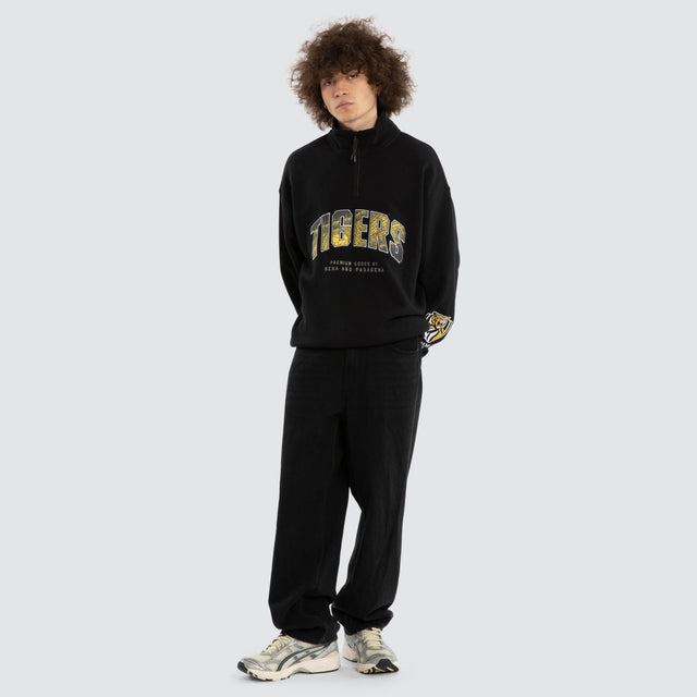 Model wears Ben Davis Richmond Tigers AFL 1/4 Zip Thru Jet Black Pullover in Black - Image 6