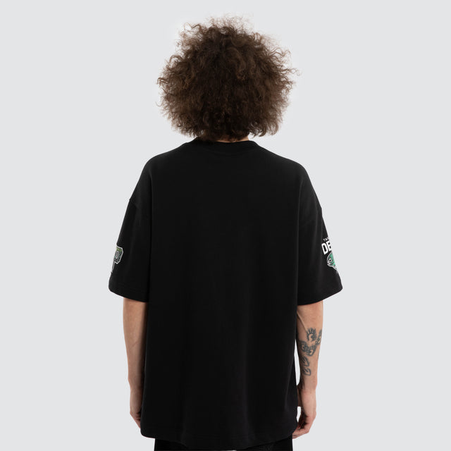 Model wears Ben Davis Tasmania Devils AFL Loopback Raptor Jet Black T-Shirts in Black - Image 5