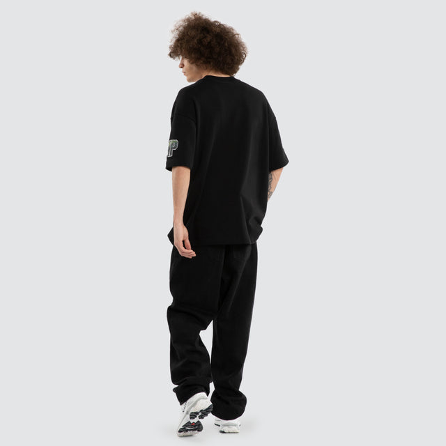 Model wears Ben Davis Tasmania Devils AFL Loopback Raptor Jet Black T-Shirts in Black - Image 7