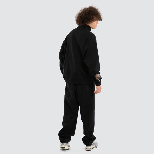 Model wears Ben Davis Hawthorn Hawks AFL 1/4 Zip Thru Jet Black Pullover in Black - Image 7