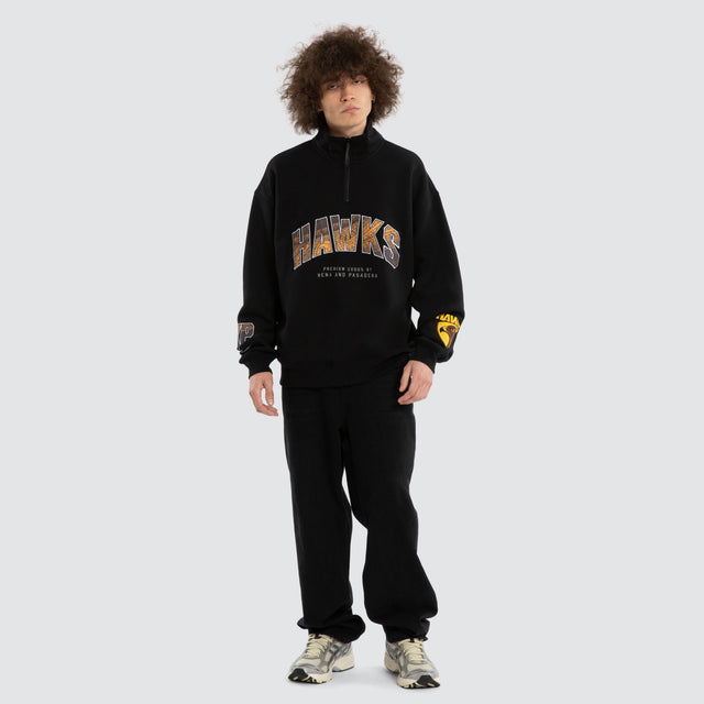 Model wears Ben Davis Hawthorn Hawks AFL 1/4 Zip Thru Jet Black Pullover in Black - Image 6