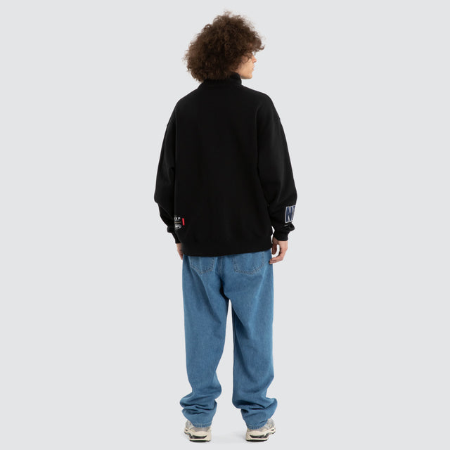 Model wears Ben Davis Geelong Cats AFL 1/4 Zip Thru Jet Black Pullover in Black - Image 6