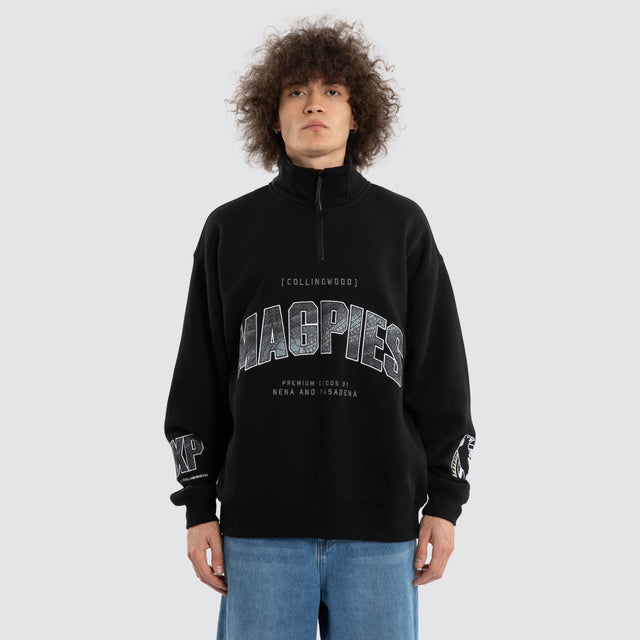 Model wears Ben Davis Collingwood Magpies AFL 1/4 Zip Thru Jet Black Pullover in Black - Image 2