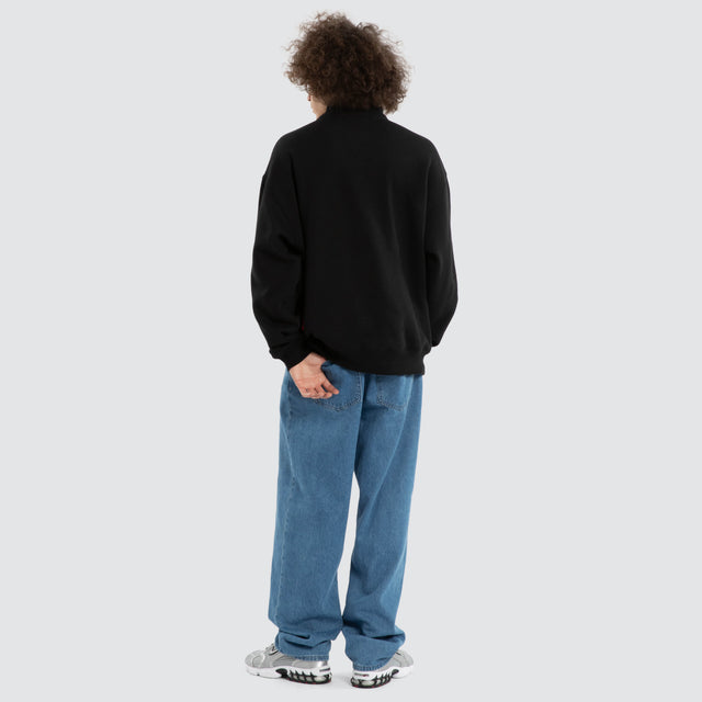 Model wears Ben Davis Collingwood Magpies AFL 1/4 Zip Thru Jet Black Pullover in Black - Image 6