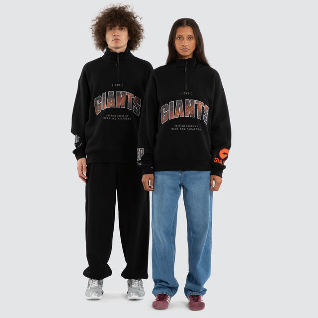 Model wears Ben Davis GWS Giants AFL 1/4 Zip Thru Jet Black Pullover in Black - Image 4