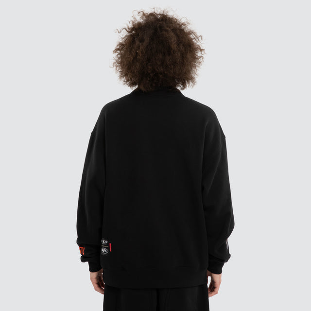 Model wears Ben Davis GWS Giants AFL 1/4 Zip Thru Jet Black Pullover in Black - Image 5