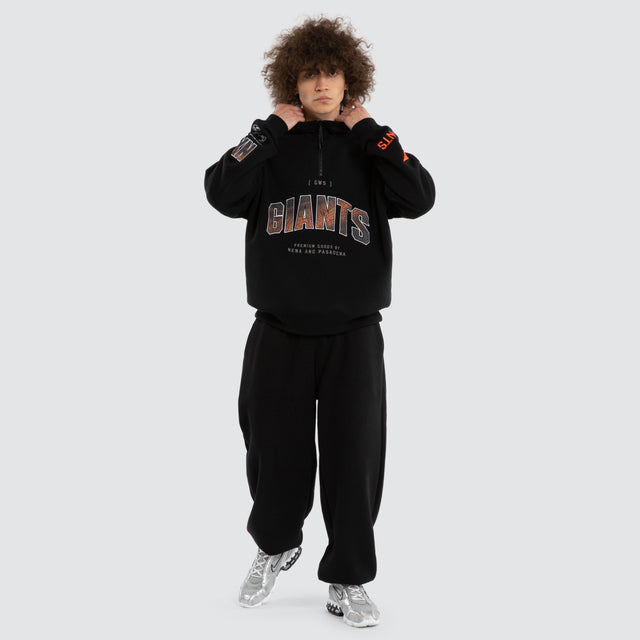 Model wears Ben Davis GWS Giants AFL 1/4 Zip Thru Jet Black Pullover in Black - Image 6