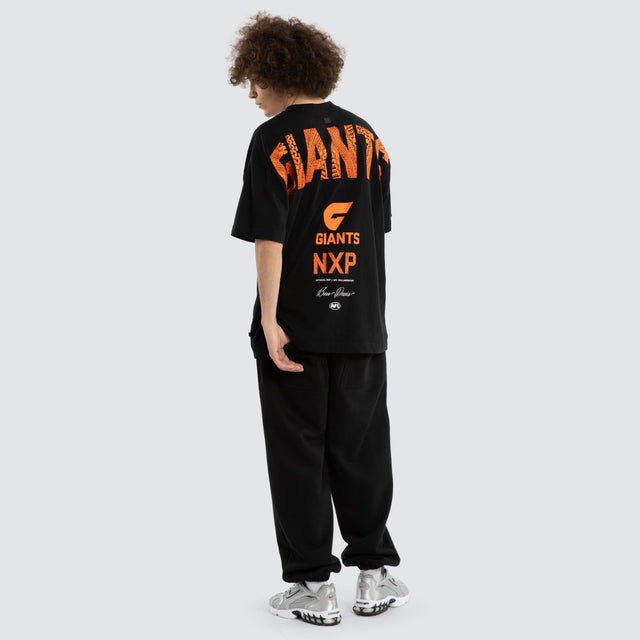 Model wears Ben Davis GWS Giants AFL Raptor Tee Jet Black T-Shirts in Black - Image 6