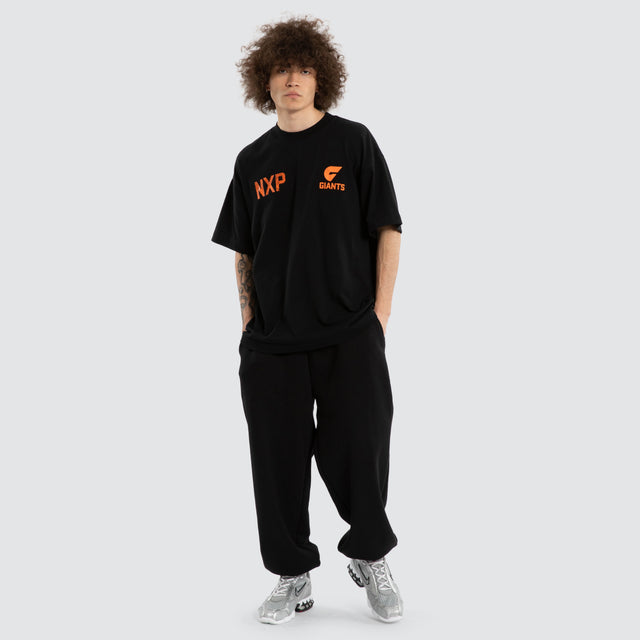 Model wears Ben Davis GWS Giants AFL Raptor Tee Jet Black T-Shirts in Black - Image 7