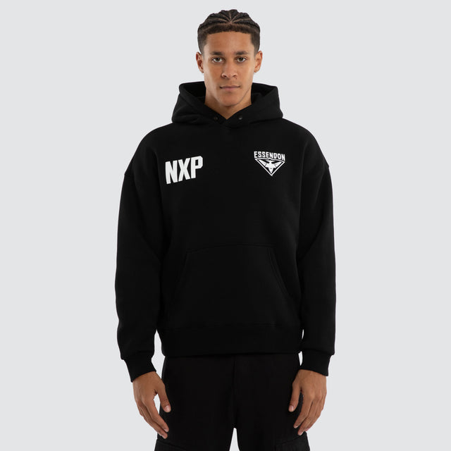 Model wears Essendon Bombers AFL Champions Box Hoodie Jet Black Hoodies in Black - Image 2