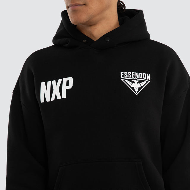 Model wears Essendon Bombers AFL Champions Box Hoodie Jet Black Hoodies in Black - Image 3